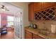 Kitchen wet bar features granite countertop, a wine rack, cabinetry, and stainless steel sink at 559 Eastern Isle Ave, Summerville, SC 29486