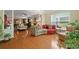 The home's layout connects living areas in a sunlit space with hardwood floors and a modern, cozy sectional sofa at 559 Eastern Isle Ave, Summerville, SC 29486