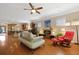 Relax in this cozy living room featuring a ceiling fan, modern furniture, and a seamless flow into the kitchen area at 559 Eastern Isle Ave, Summerville, SC 29486