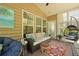 Inviting screened porch with comfortable seating, a ceiling fan, and views of the outdoors at 559 Eastern Isle Ave, Summerville, SC 29486