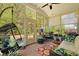 Relaxing screened porch featuring ample seating, nature views, and natural light at 559 Eastern Isle Ave, Summerville, SC 29486