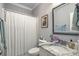 Charming bathroom featuring a stylish marble vanity, a framed mirror, and a shower with a curtain at 5950 Lowell Reed Rd, Ravenel, SC 29470