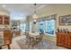 Inviting dining area featuring a decorative light fixture, sunny windows, and access to a cozy living space at 5950 Lowell Reed Rd, Ravenel, SC 29470