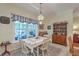 Sunlit dining area with large window and traditional furnishings at 5950 Lowell Reed Rd, Ravenel, SC 29470