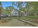 Charming home with a screened porch and a neatly maintained lawn, along with a truck in the driveway at 5950 Lowell Reed Rd, Ravenel, SC 29470