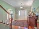 Elegant foyer showcasing hardwood floors, staircase, and stylish decor at 5950 Lowell Reed Rd, Ravenel, SC 29470