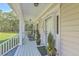 View of the front porch featuring rocking chairs, plants, and ample space at 5950 Lowell Reed Rd, Ravenel, SC 29470