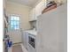 Practical laundry room with a modern washer and dryer set, ample cabinet space, and convenient backyard access at 5950 Lowell Reed Rd, Ravenel, SC 29470