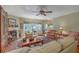 Cozy living room with fireplace, ceiling fan, and plenty of natural light at 5950 Lowell Reed Rd, Ravenel, SC 29470