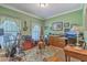 Inviting home office filled with natural light, featuring hardwood floors and musical instruments at 5950 Lowell Reed Rd, Ravenel, SC 29470