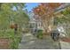 Stone patio with a grill, outdoor seating, potted plants, and an umbrella near the home at 5950 Lowell Reed Rd, Ravenel, SC 29470
