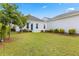 Lovely backyard with plush green grass, landscaped beds, and a charming home with a blue door at 607 Heartwood Ln, Summerville, SC 29486