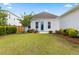 Charming backyard showcasing a well-maintained lawn, landscape beds, and a stylish blue door at 607 Heartwood Ln, Summerville, SC 29486