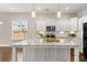 Bright kitchen features a center island with granite countertops and stainless steel appliances, great for entertaining at 607 Heartwood Ln, Summerville, SC 29486