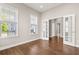 Bright, airy living room showcases gleaming hardwood floors and elegant French doors leading to another space at 607 Heartwood Ln, Summerville, SC 29486