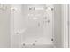 Bathroom featuring all white tiled shower with glass door and a built in bench at 607 Heartwood Ln, Summerville, SC 29486