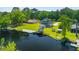 Expansive waterfront property with a well-maintained lawn, private dock, and cozy green home at 643 Backfield Rd, Walterboro, SC 29488