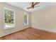 Bright bedroom features hardwood floors, crown molding, ceiling fan, and large windows at 643 Backfield Rd, Walterboro, SC 29488