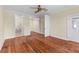 Spacious bedroom with a ceiling fan, wood floors, and access to an ensuite bathroom and walk in closet at 643 Backfield Rd, Walterboro, SC 29488