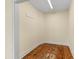 Walk-in closet featuring wood flooring, neutral walls, white trim, and overhead lighting at 643 Backfield Rd, Walterboro, SC 29488