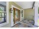 Inviting front porch with decorative tile, charming sidelight windows, and an elegant wood door at 643 Backfield Rd, Walterboro, SC 29488