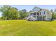 The home boasts a sprawling lawn, raised foundation, screened porch, and ample space for outdoor enjoyment at 643 Backfield Rd, Walterboro, SC 29488