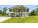 Inviting two-story home featuring a charming staircase entrance and lush palm trees at 643 Backfield Rd, Walterboro, SC 29488