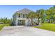 Charming raised home with a spacious driveway, adorned with two palm trees and a manicured lawn at 643 Backfield Rd, Walterboro, SC 29488
