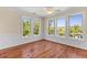 Sunny living room with hardwood floors and large windows with water views at 643 Backfield Rd, Walterboro, SC 29488