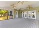 Covered porch features wood plank flooring, ceiling fans, and access to screened-in porch at 643 Backfield Rd, Walterboro, SC 29488