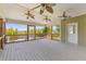 Spacious covered porch with wood plank flooring, ceiling fans, and water view at 643 Backfield Rd, Walterboro, SC 29488