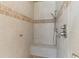 Tile shower with a bench, mosaic accents, and modern showerhead at 643 Backfield Rd, Walterboro, SC 29488