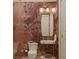 Stylish bathroom featuring floral wallpaper, a modern sink with golden fixtures, and a sleek, glass-enclosed shower at 8 Homel Pl, Charleston, SC 29403