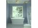Relaxing bathroom featuring a freestanding tub, bright natural light, and elegant fixtures for a luxurious bathing experience at 8 Homel Pl, Charleston, SC 29403