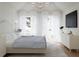 Sunlit bedroom featuring light wood floors, sheered curtains, and a modern dresser at 8 Homel Pl, Charleston, SC 29403