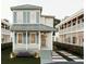 Charming two-story home featuring a welcoming front porch and beautifully landscaped front yard at 8 Homel Pl, Charleston, SC 29403