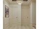 Elegant hallway features a decorative chandelier, neutral walls, and checkered flooring creating a bright and welcoming space at 8 Homel Pl, Charleston, SC 29403