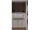 Functional laundry room features a farmhouse sink, neutral cabinets, and ample counter space for efficient chore management at 8 Homel Pl, Charleston, SC 29403