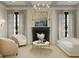 Elegant living room featuring a sleek fireplace, modern chandelier, and comfortable seating area with neutral tones at 8 Homel Pl, Charleston, SC 29403