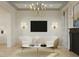 Bright living room with a modern chandelier, stylish seating, and a large flat screen TV at 8 Homel Pl, Charleston, SC 29403