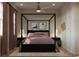 Beautiful main bedroom with a four-poster bed, accent wall decor and two bedside lamps at 8 Homel Pl, Charleston, SC 29403