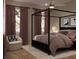 Cozy primary bedroom featuring a four-poster bed, plush bedding, and soft, inviting decor at 8 Homel Pl, Charleston, SC 29403