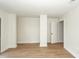 Unfinished basement featuring an open doorway, hardwood floors, and neutral walls at 8483 Yadkin Cir # C, North Charleston, SC 29418