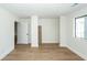 Unfinished basement with hardwood floors, neutral walls and columns, and window at 8483 Yadkin Cir # C, North Charleston, SC 29418