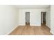 Bedroom showing bathroom and closet access, hardwood floors, white walls and trim at 8483 Yadkin Cir # C, North Charleston, SC 29418
