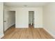 Spacious bedroom with wood floors and doorways leading to a closet and bathroom at 8483 Yadkin Cir # C, North Charleston, SC 29418