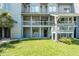 Exterior shot of multi-Gathering unit featuring porches and green grass at 8483 Yadkin Cir # C, North Charleston, SC 29418