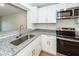 Updated kitchen with white cabinets, granite counters and stainless steel appliances at 8483 Yadkin Cir # C, North Charleston, SC 29418