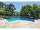 Clean swimming pool surrounded by a white fence and green trees at 8483 Yadkin Cir # C, North Charleston, SC 29418