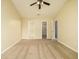 Spacious bedroom featuring neutral walls, carpet flooring, ceiling fan, and closet and bathroom access at 8679 Grassy Oak Trl, North Charleston, SC 29420